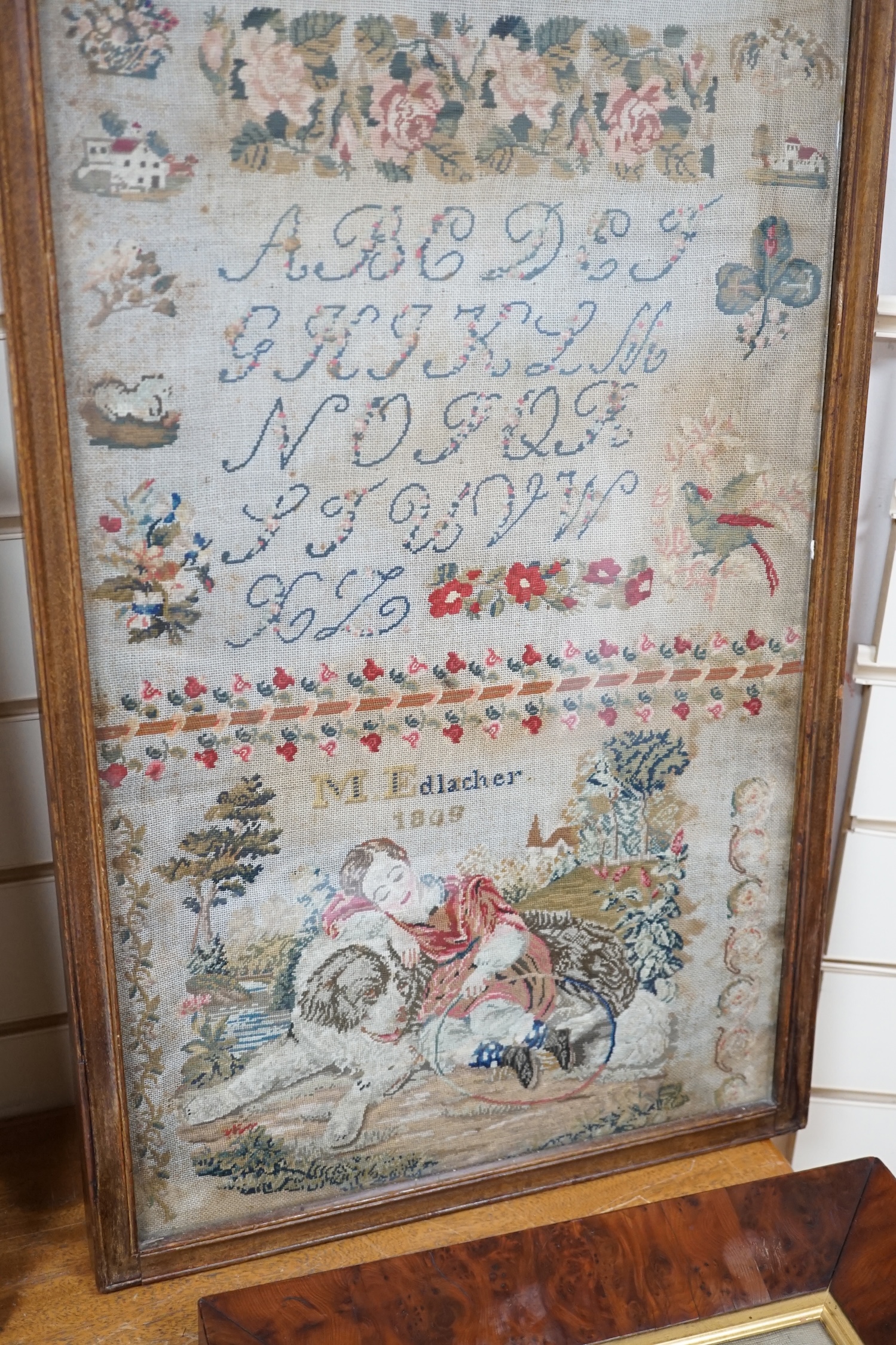 Two mid 19th century embroideries; a framed sampler dated 1809 and an embroidered figurative panel, largest 114 x 42cm. Condition - poor